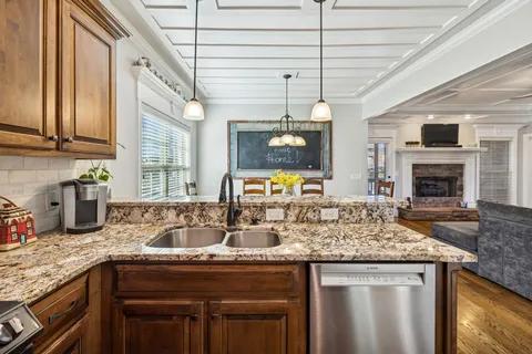 a spacious bedroom with a bed and a chandelier