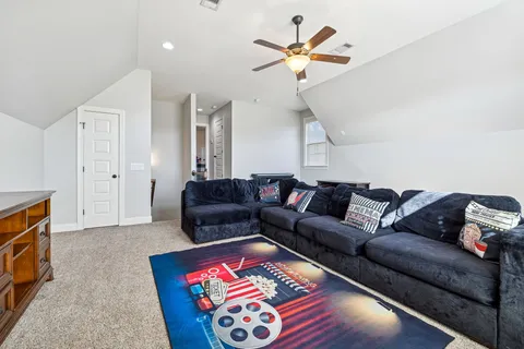 a front view of house with yard and trees around