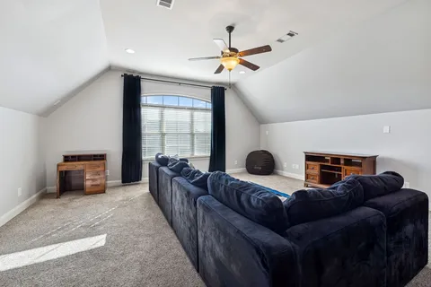 a front view of house with yard and trees around