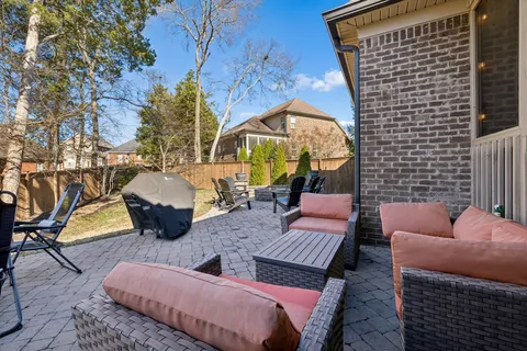a view of a house with swimming pool and sitting area