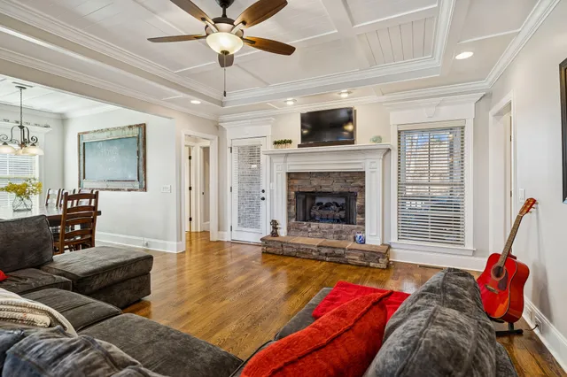 a living room with furniture and a chandelier