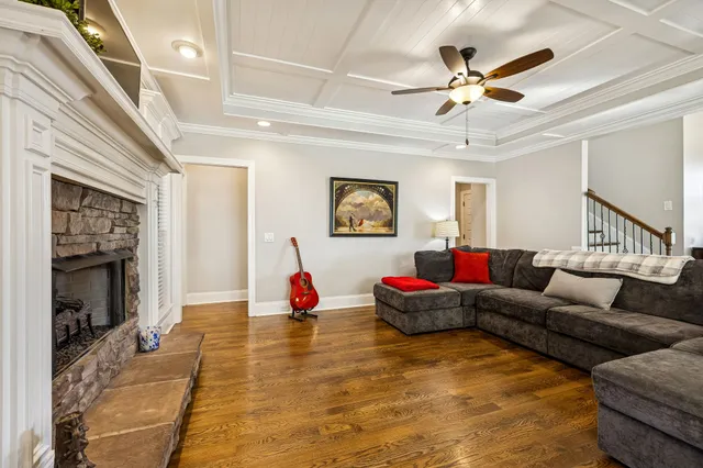 a living room with a fireplace and a flat screen tv