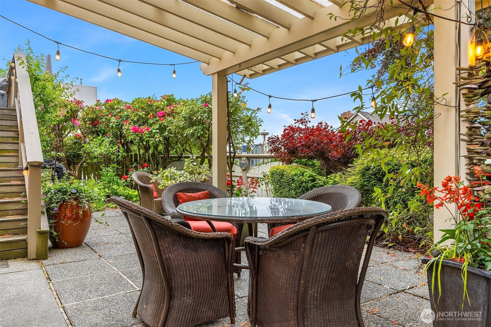 525 West Prospect Street, Unit A Seattle, WA 98119 - Photo 25 of 31 a view of a patio with table and chairs potted plants
