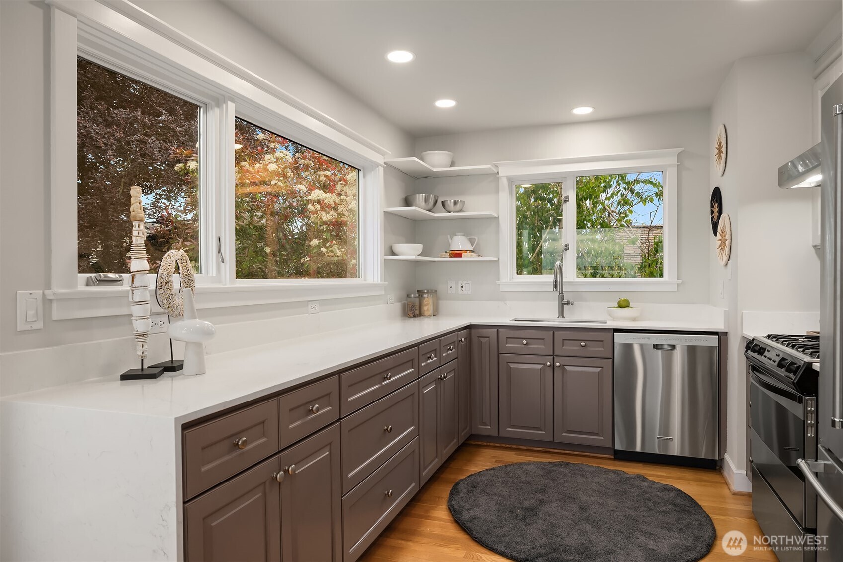 525 West Prospect Street, Unit A Seattle, WA 98119 - Photo 3 of 31 a kitchen with stainless steel appliances granite countertop a sink stove and cabinets