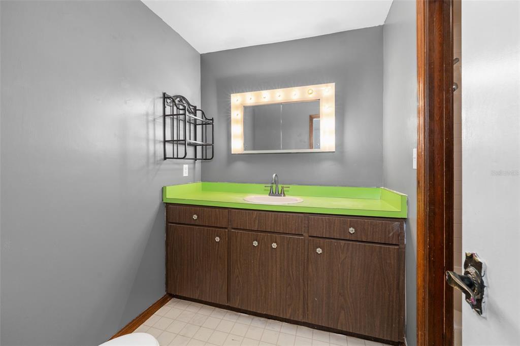 4703 Northwest 124th Street Gainesville, FL 32606 - Photo 38 of 55 a bathroom with a sink and a mirror