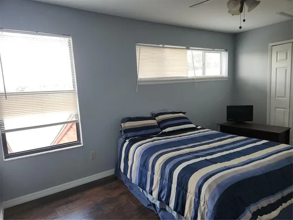 a bedroom with two beds and a window