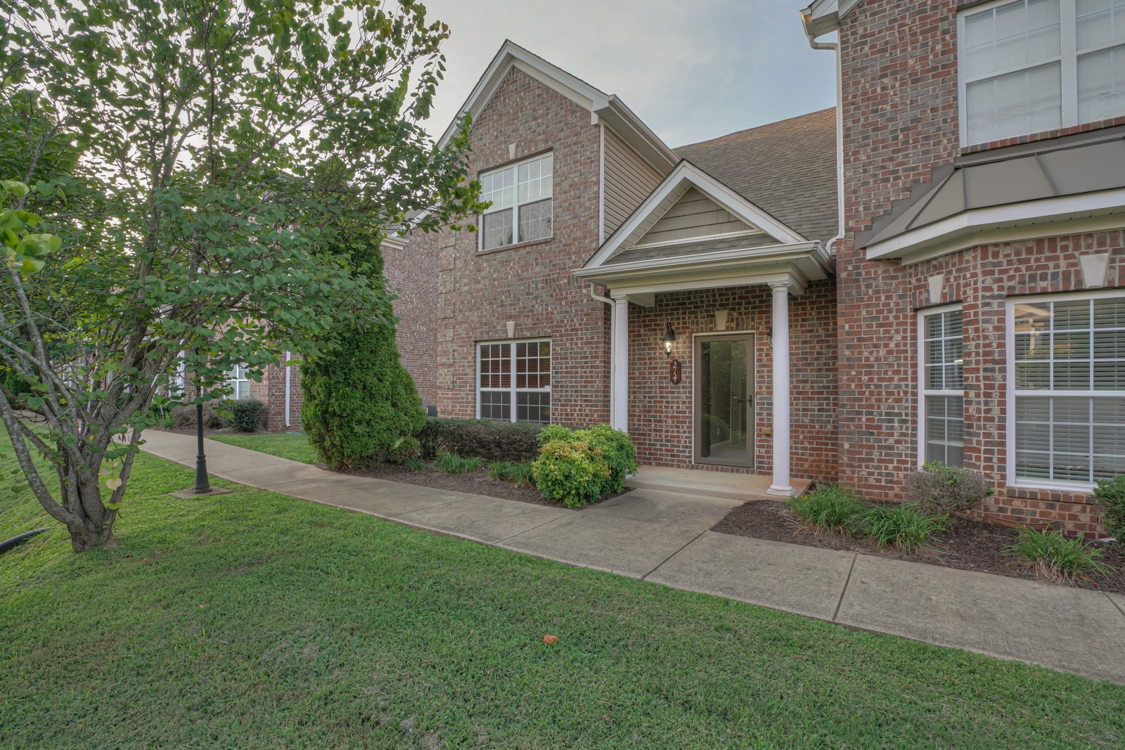 214 Rowlette Circle Murfreesboro, TN 37127 - Photo 22 of 27 a view of brick house with a yard and plants
