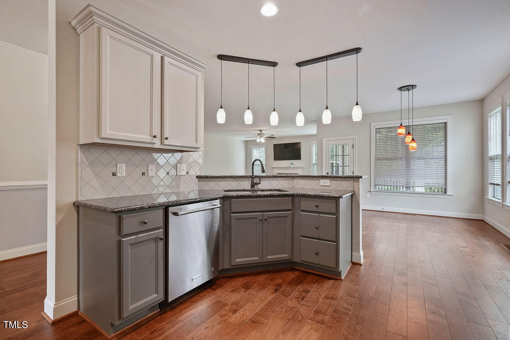 1124 Armsleigh Court Raleigh, NC 27603 - Photo 13 of 33 a kitchen with granite countertop wooden cabinets and white appliances