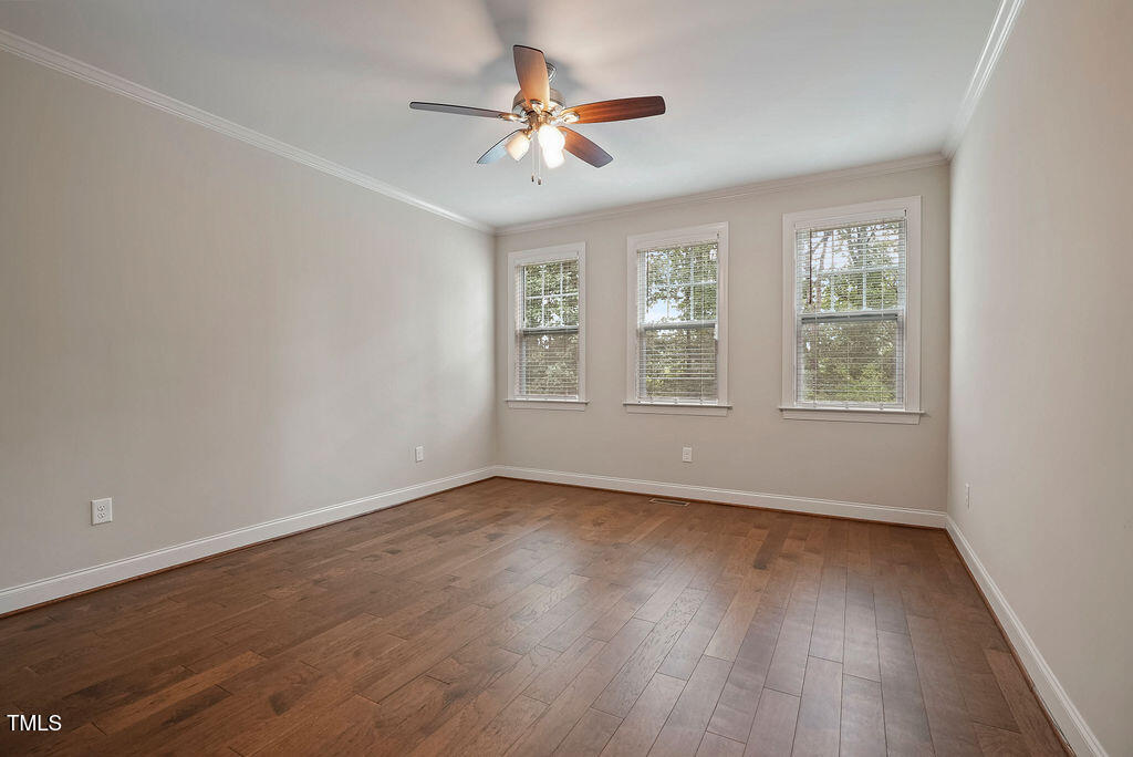 1124 Armsleigh Court Raleigh, NC 27603 - Photo 16 of 33 a view of an empty room with wooden floor and a window