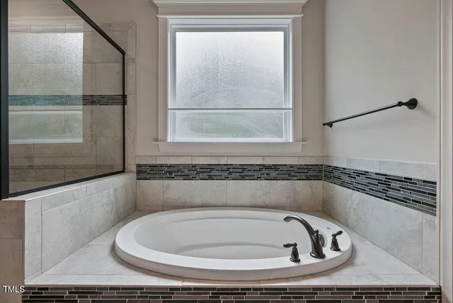 a bathroom with a bathtub and a shower