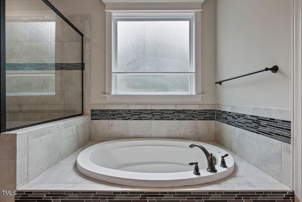 1124 Armsleigh Court Raleigh, NC 27603 - Photo 18 of 33 a bathroom with a bathtub and a shower
