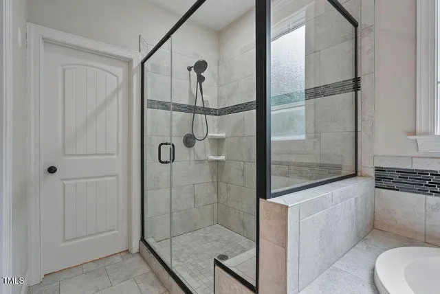 a bathroom with a shower and a sink