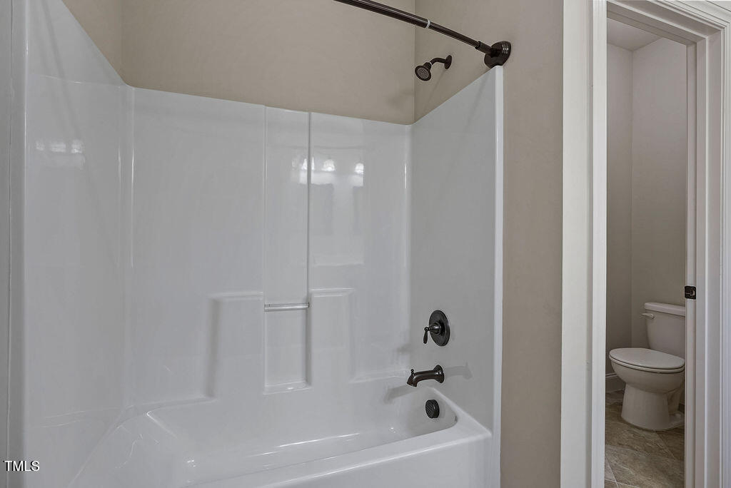 1124 Armsleigh Court Raleigh, NC 27603 - Photo 26 of 33 a bathroom with a bathtub and a shower