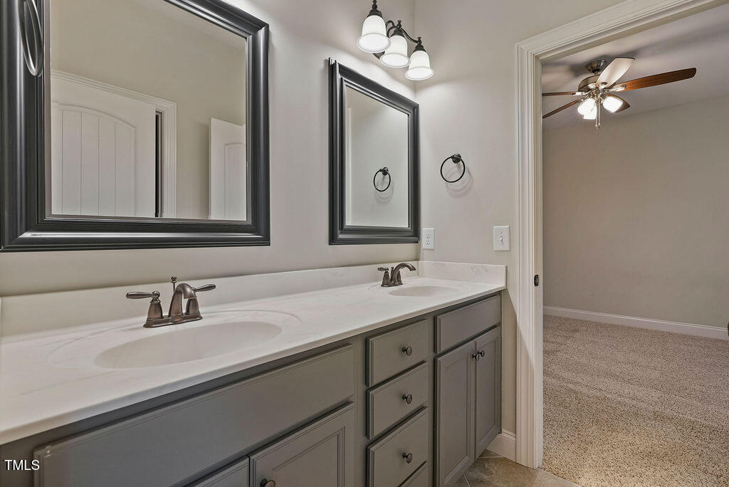 1124 Armsleigh Court Raleigh, NC 27603 - Photo 29 of 33 a bathroom with double vanity sinks and a mirror