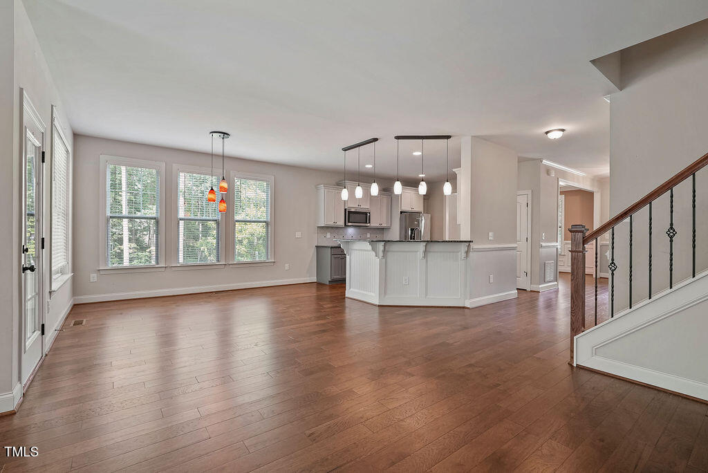 1124 Armsleigh Court Raleigh, NC 27603 - Photo 7 of 33 a view of a kitchen with furniture and wooden floor