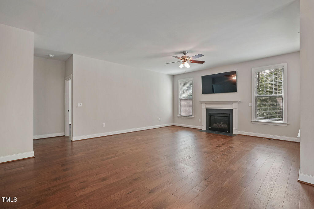 1124 Armsleigh Court Raleigh, NC 27603 - Photo 8 of 33 a view of an empty room with a fireplace and a window