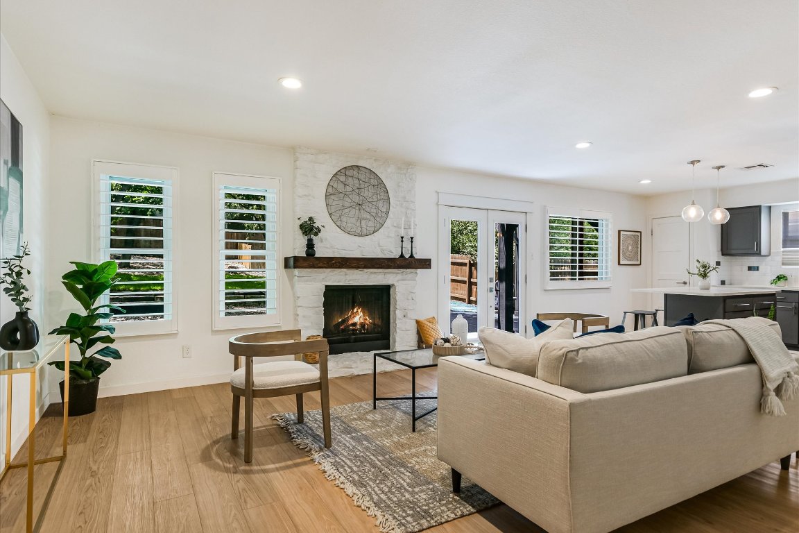 a living room with furniture a fireplace and a potted plant