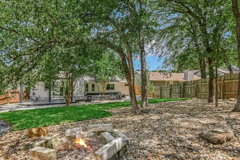 a view of a backyard with large trees