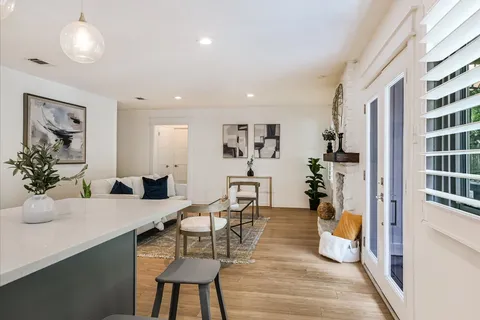 a living room with fireplace furniture and a wooden floor