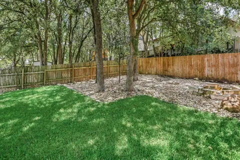 a view of a patio with table and chairs and potted plants