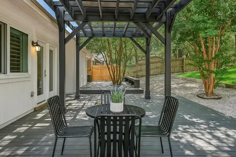a view of an outdoor dining space with a table and chairs