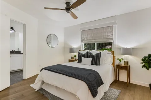 a bedroom with a bed and a chandelier