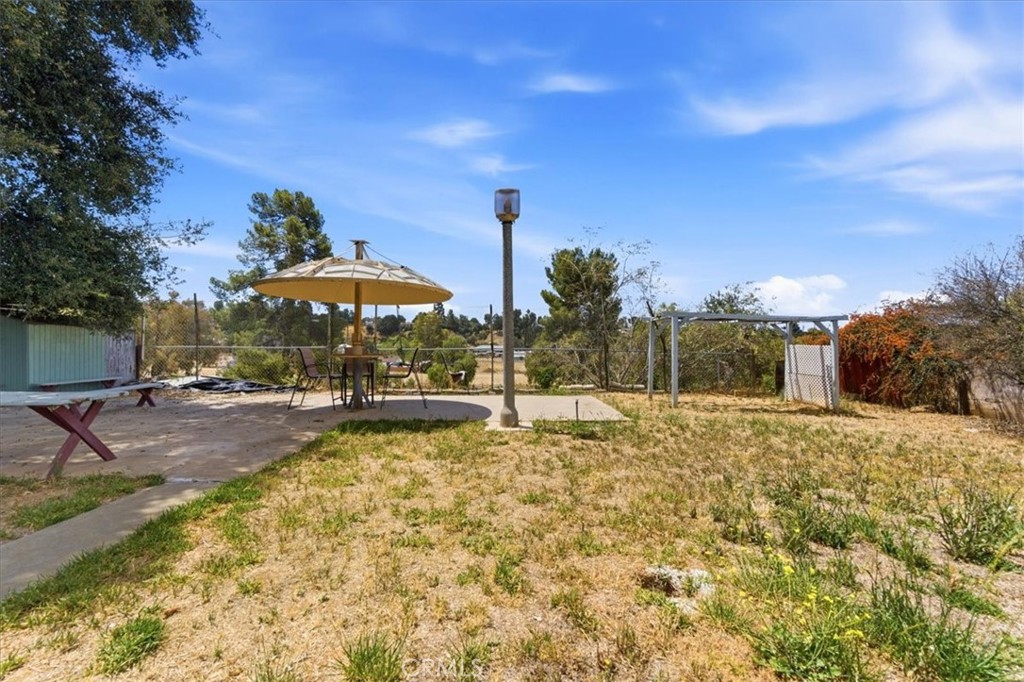 34863 Wildwood Canyon Road Yucaipa, CA 92399 - Photo 16 of 22 a view of a swimming pool and lounge chairs