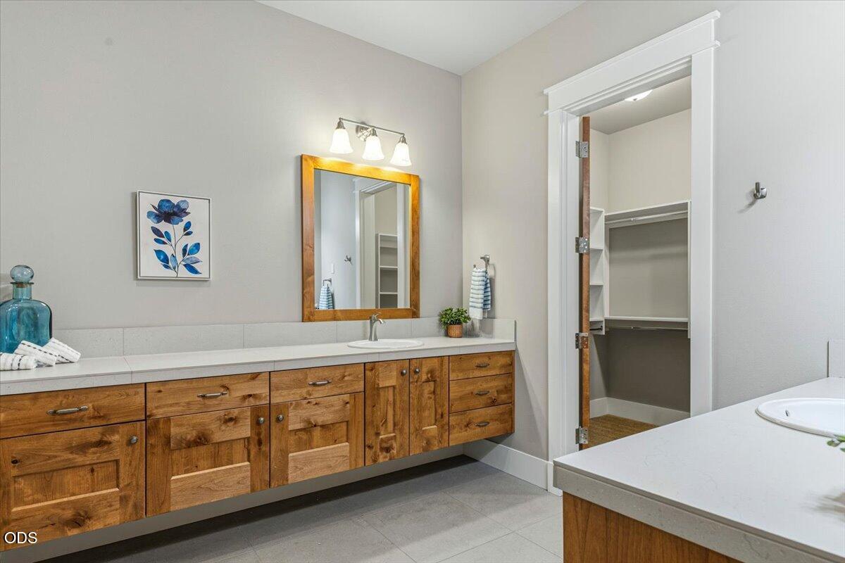 61333 Kindle Rock Loop Bend, OR 97702 - Photo 33 of 53 a spacious bathroom with a double vanity sink and a mirror