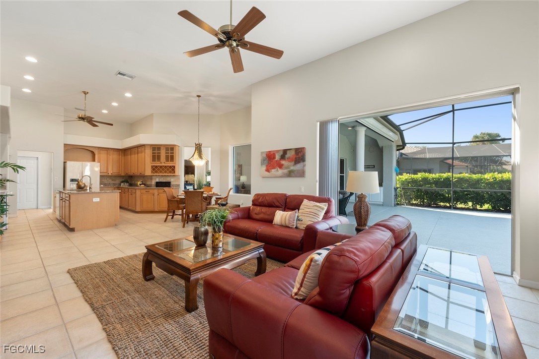 23180 Whispering Ridge Drive Estero, FL 34135 - Photo 17 of 42 a living room with furniture kitchen view and a large window