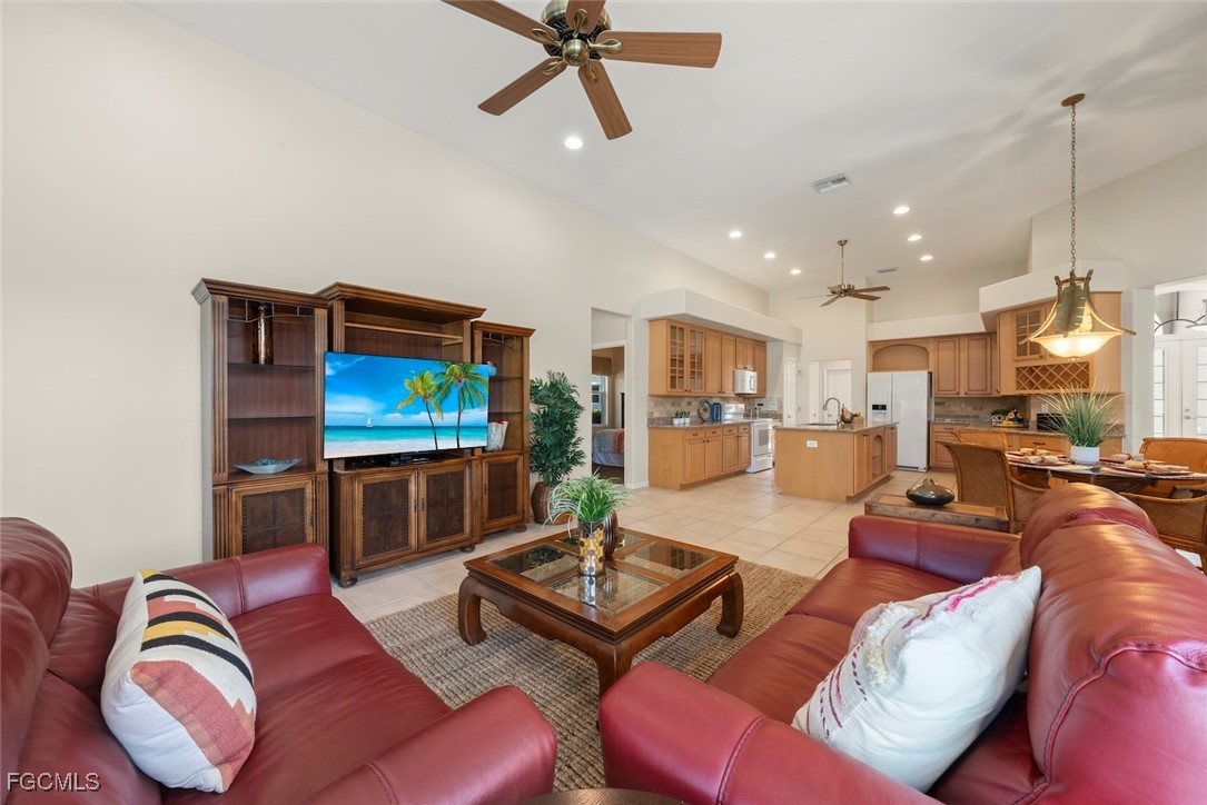 23180 Whispering Ridge Drive Estero, FL 34135 - Photo 18 of 42 a living room with furniture kitchen view and a flat screen tv