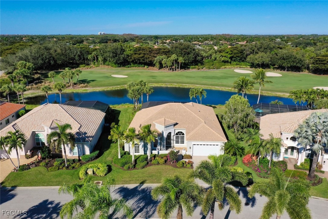 23180 Whispering Ridge Drive Estero, FL 34135 - Photo 2 of 42 an aerial view of a house with outdoor space and trees all around
