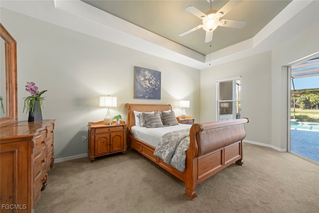 23180 Whispering Ridge Drive Estero, FL 34135 - Photo 22 of 42 a bed room with a bed and a chandelier