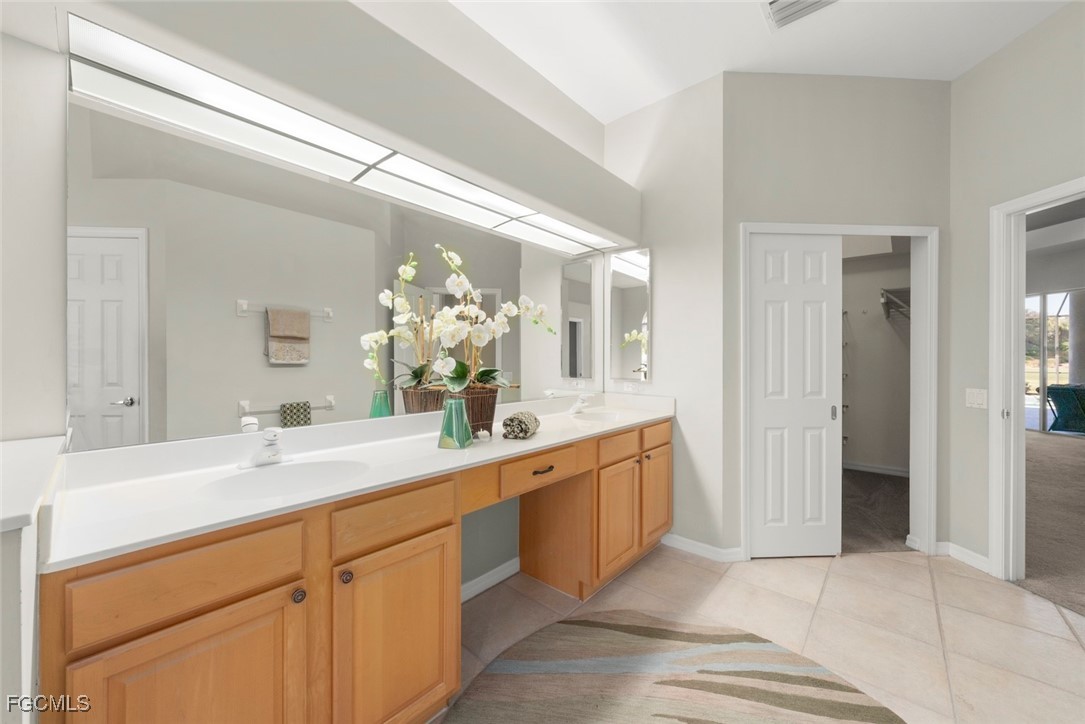 23180 Whispering Ridge Drive Estero, FL 34135 - Photo 26 of 42 a spacious bathroom with a sink and a mirror