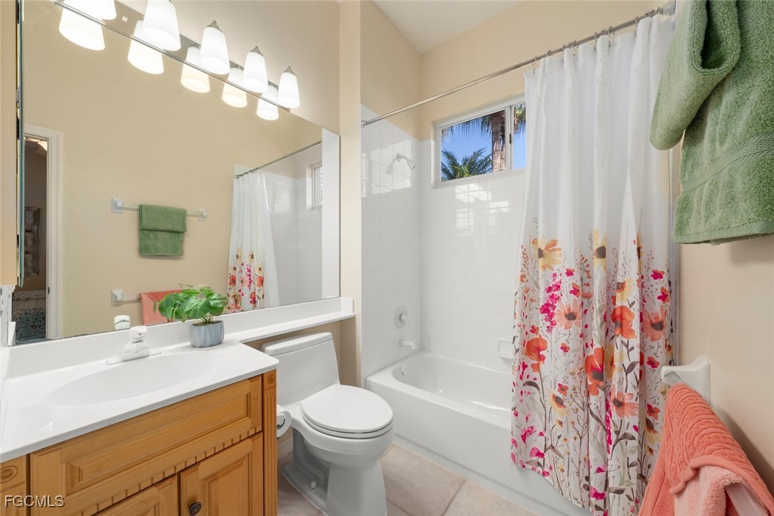 23180 Whispering Ridge Drive Estero, FL 34135 - Photo 29 of 42 a bathroom with a sink a toilet and shower