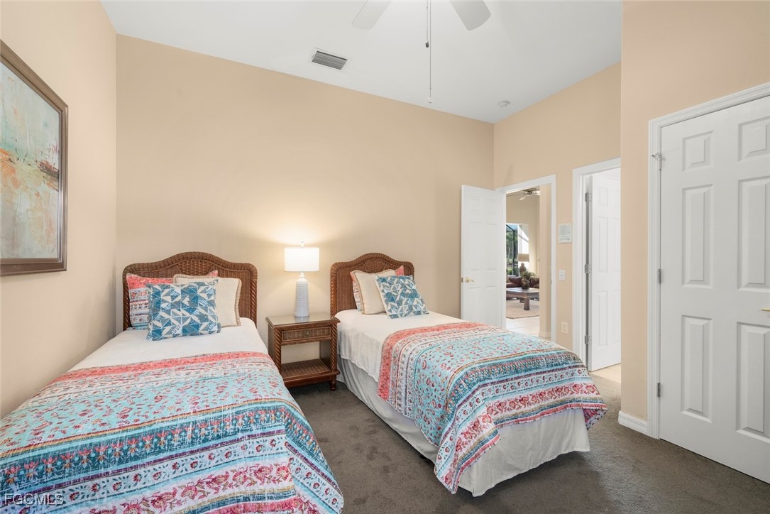 23180 Whispering Ridge Drive Estero, FL 34135 - Photo 31 of 42 a bedroom with a bed and lamp