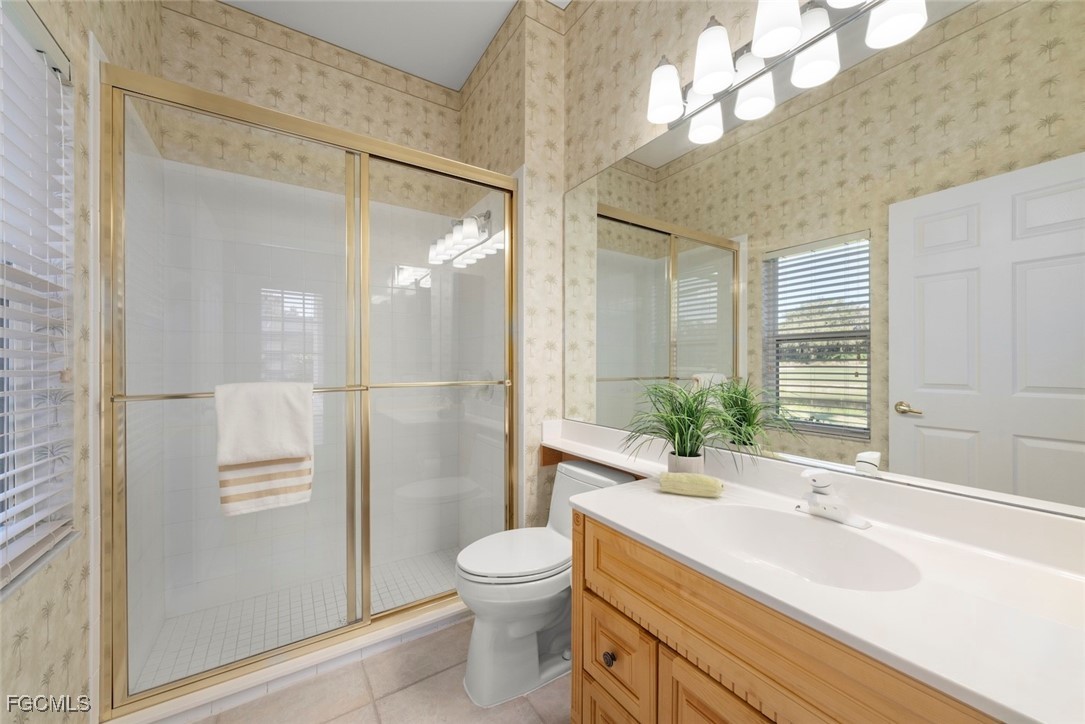 23180 Whispering Ridge Drive Estero, FL 34135 - Photo 33 of 42 a bathroom with a sink a toilet and shower