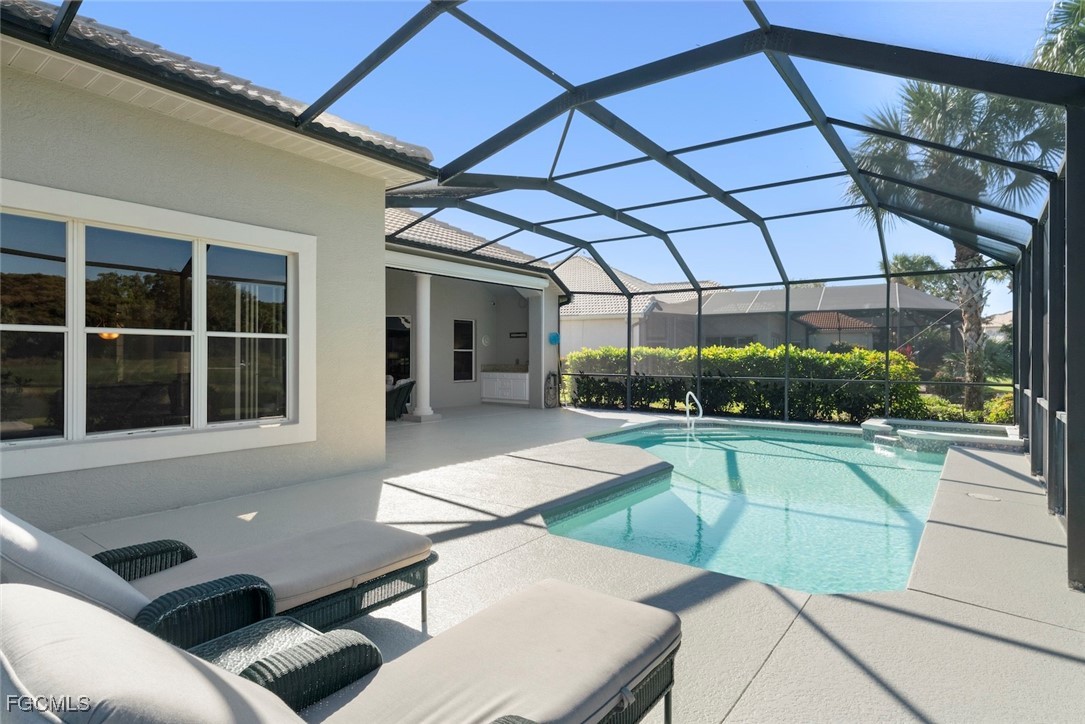 23180 Whispering Ridge Drive Estero, FL 34135 - Photo 37 of 42 a view of a patio with couches table and chairs