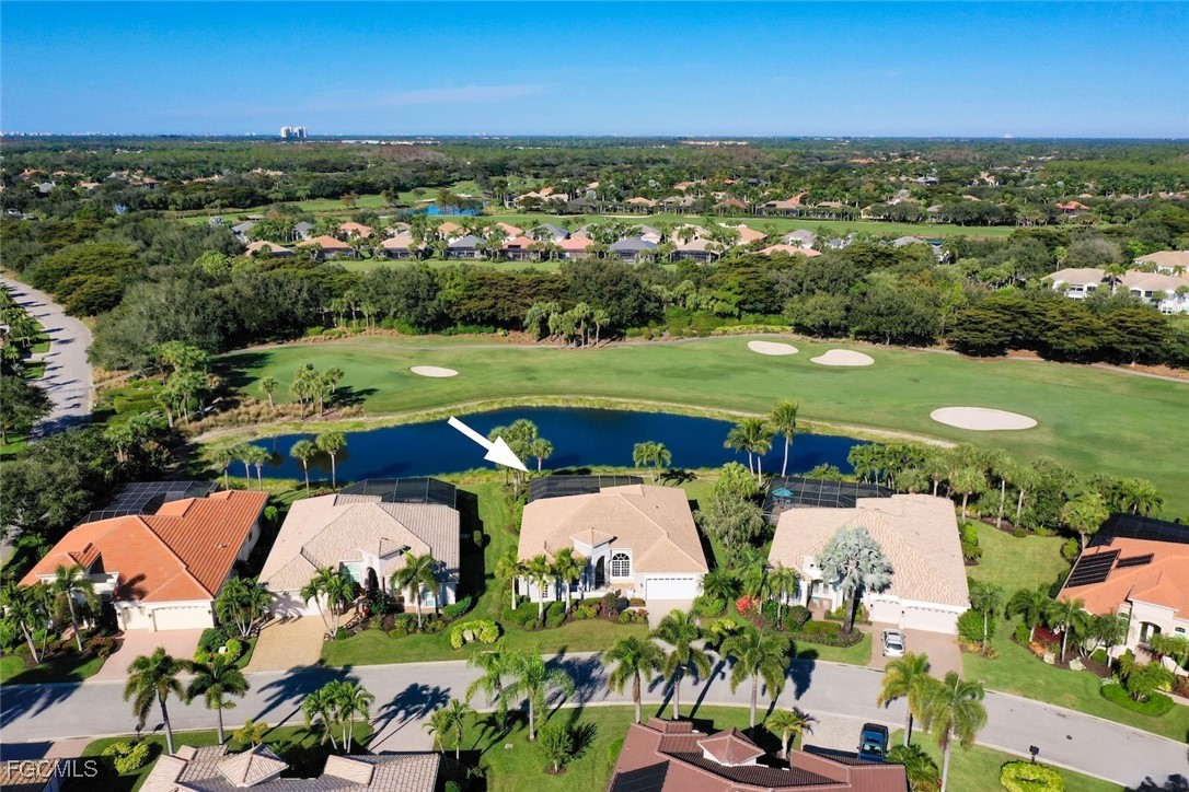 23180 Whispering Ridge Drive Estero, FL 34135 - Photo 39 of 42 an aerial view of a city with lots of residential buildings ocean and mountain view in back