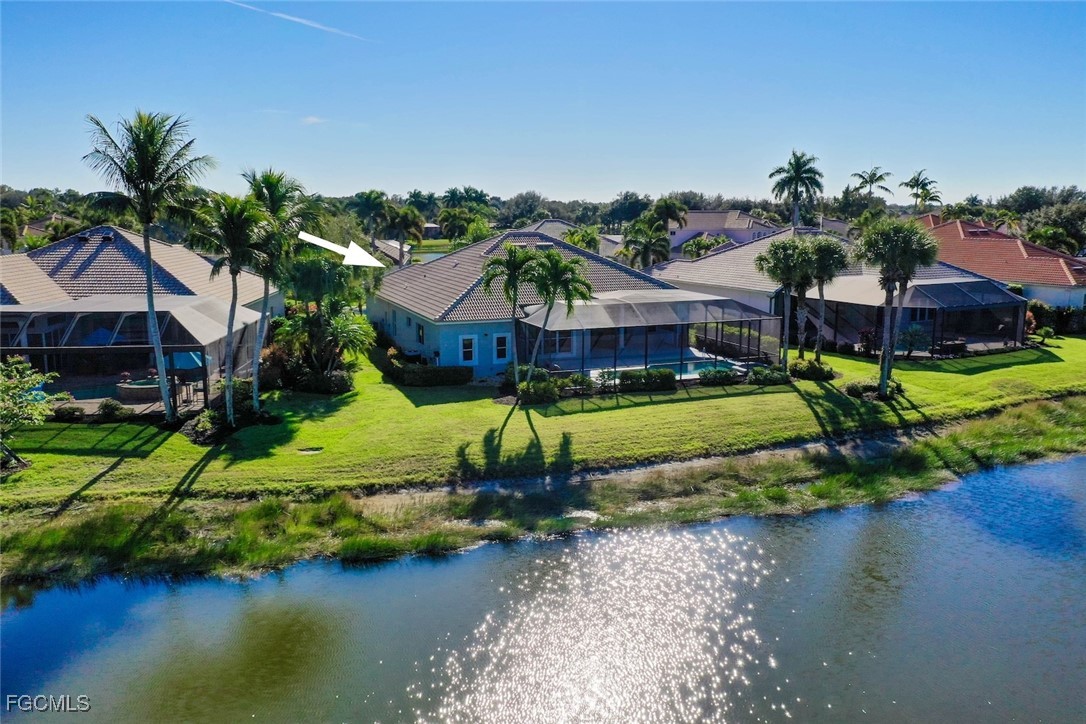 23180 Whispering Ridge Drive Estero, FL 34135 - Photo 40 of 42 a aerial view of a house with a garden and lake view