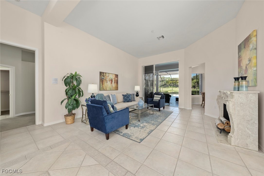 23180 Whispering Ridge Drive Estero, FL 34135 - Photo 10 of 42 a living room with furniture and a potted plant