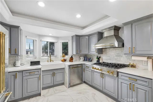 a kitchen with stainless steel appliances a refrigerator sink and stove