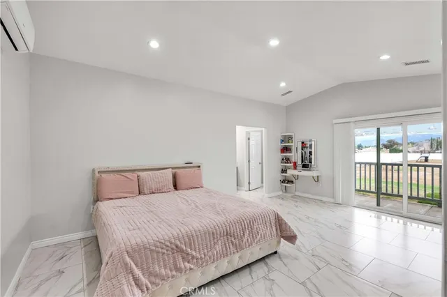 a spacious bedroom with a large bed and a dresser