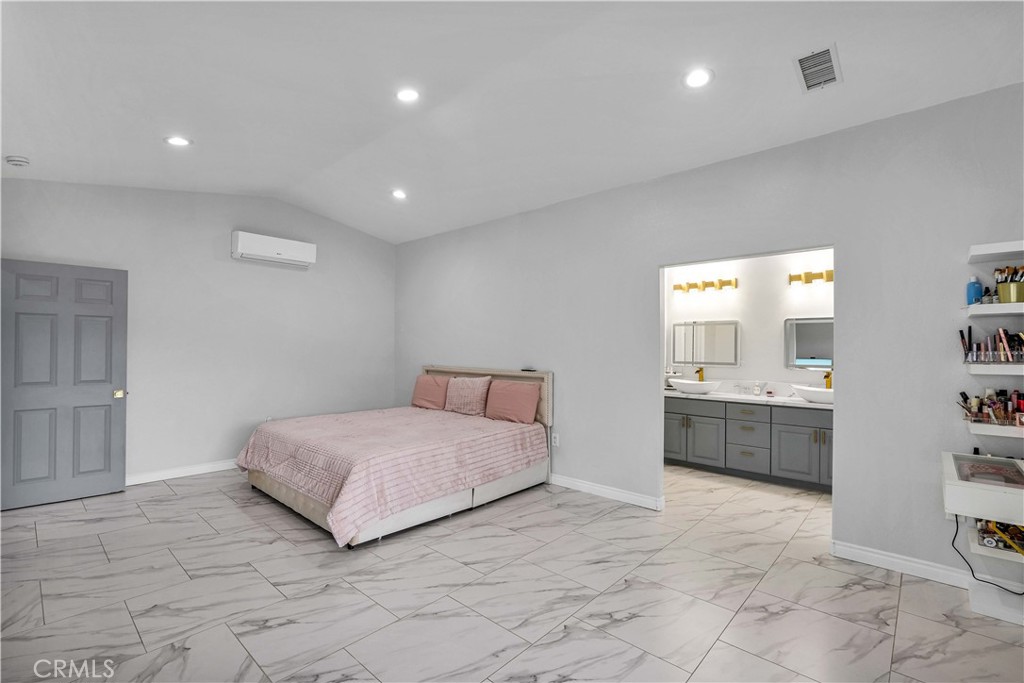 35716 Wildwood Canyon Road Yucaipa, CA 92399 - Photo 18 of 57 a spacious bedroom with a large bed and a dresser