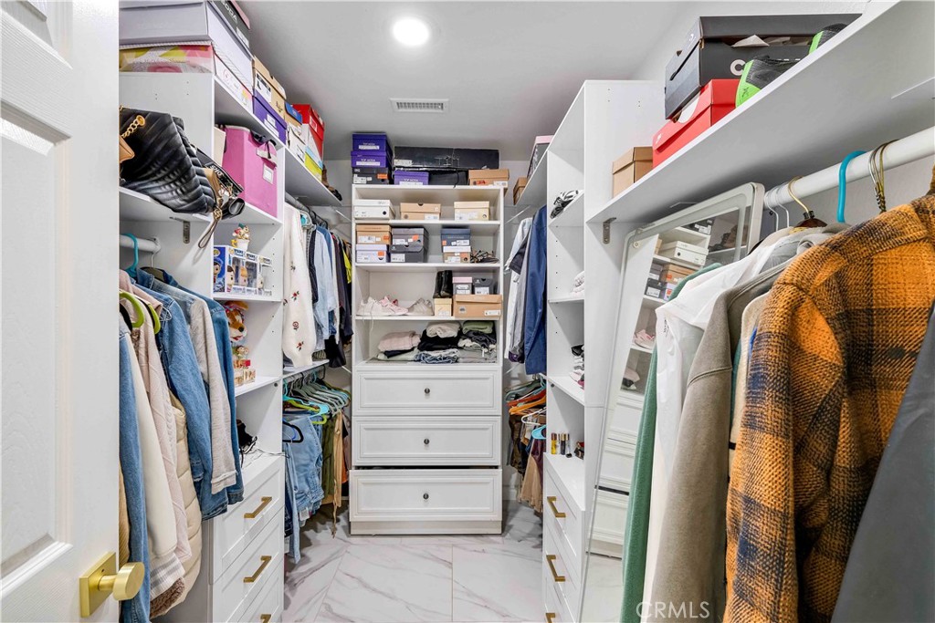 35716 Wildwood Canyon Road Yucaipa, CA 92399 - Photo 20 of 57 a view of walk in closet with clothes and shoes
