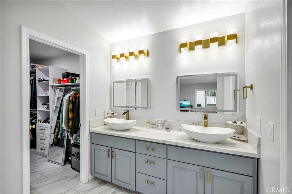 35716 Wildwood Canyon Road Yucaipa, CA 92399 - Photo 21 of 57 a bathroom with a double vanity sink and a mirror