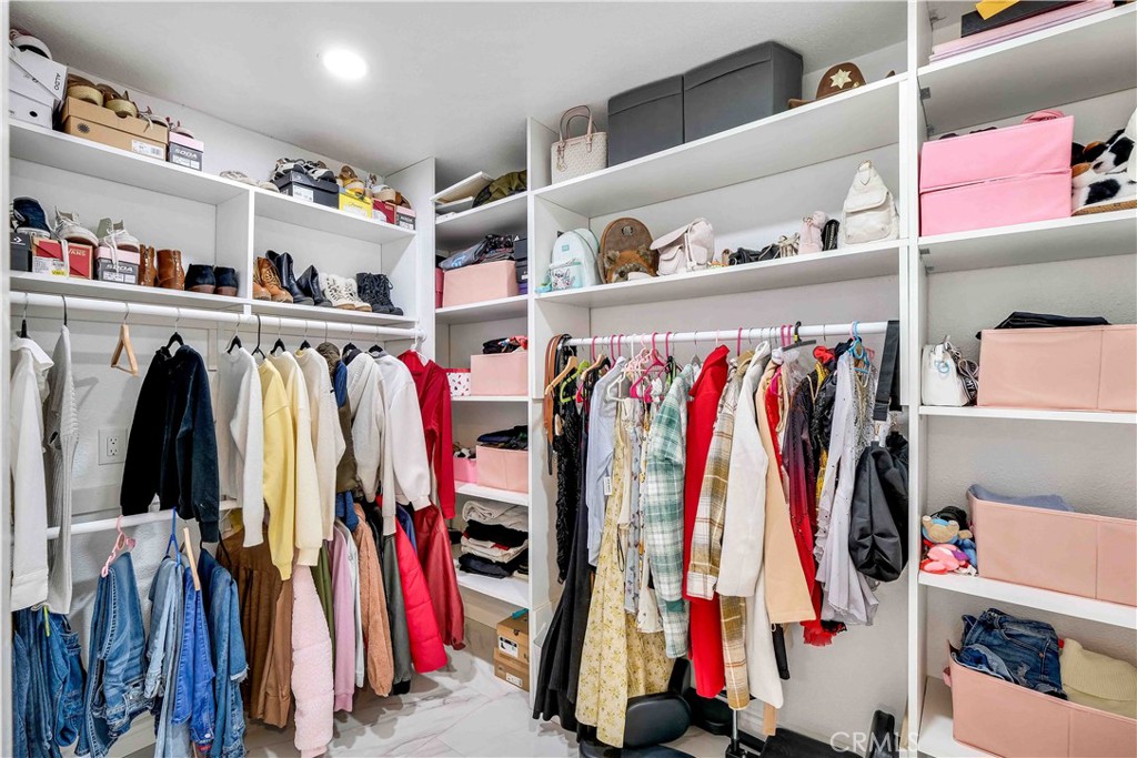 35716 Wildwood Canyon Road Yucaipa, CA 92399 - Photo 29 of 57 a view of walk in closet with clothes and shoes