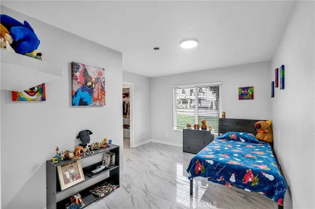 a bathroom with a granite countertop sink toilet and mirror