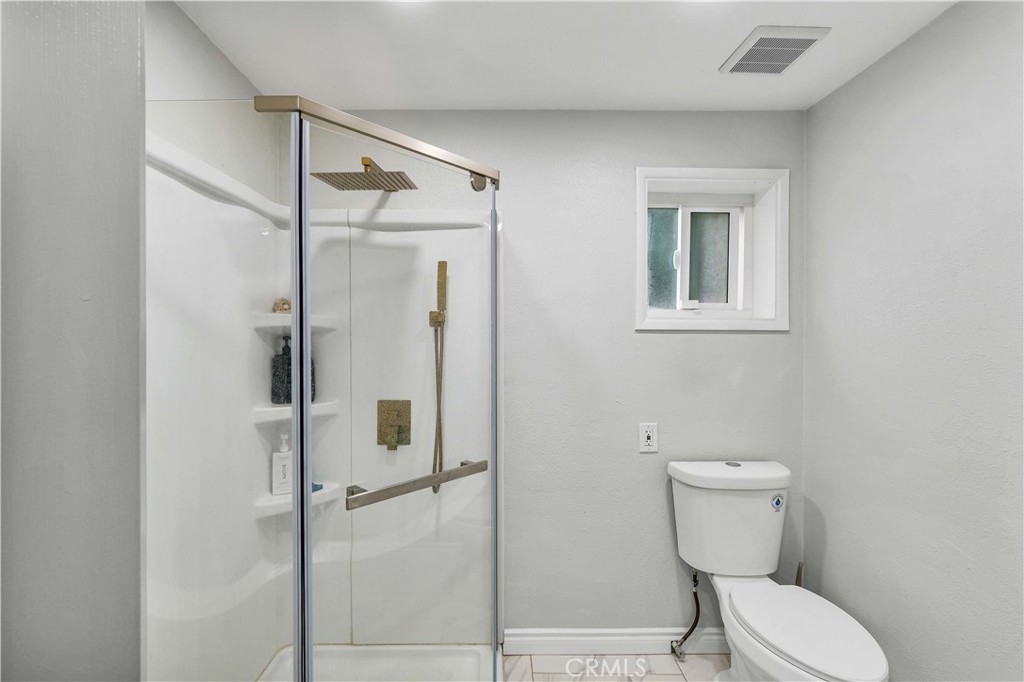 35716 Wildwood Canyon Road Yucaipa, CA 92399 - Photo 37 of 57 a bathroom with a toilet and a shower