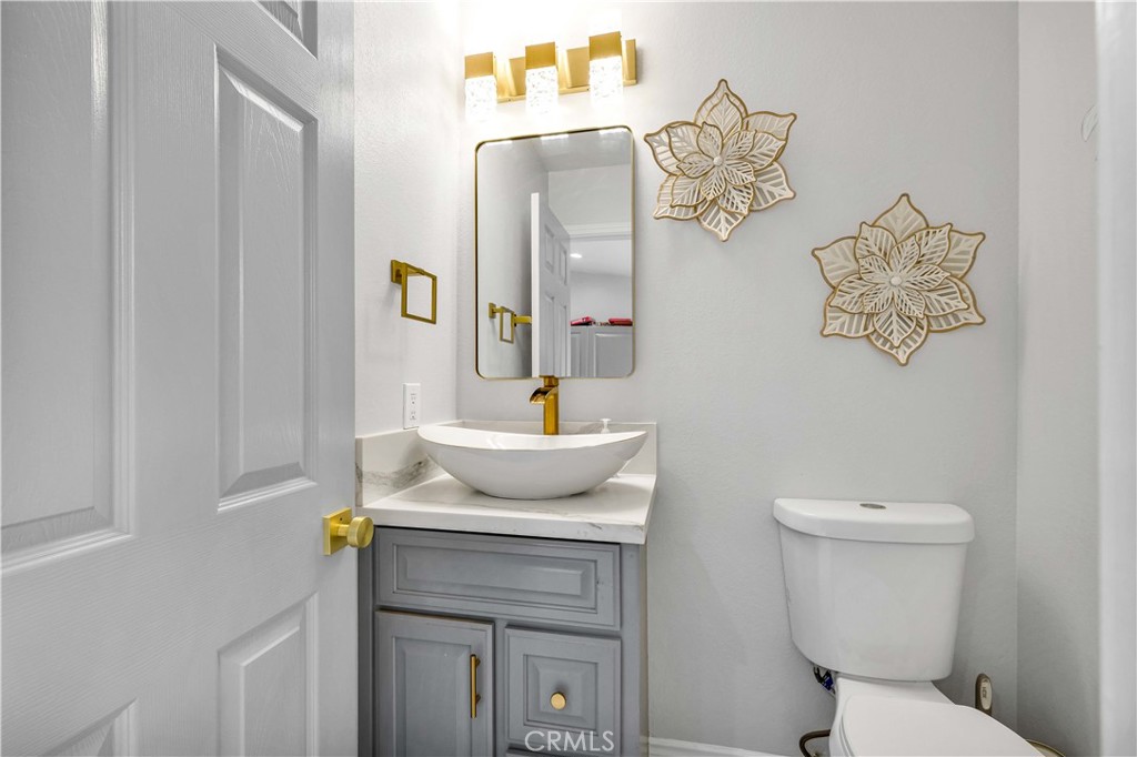 35716 Wildwood Canyon Road Yucaipa, CA 92399 - Photo 38 of 57 a bathroom with a toilet sink and mirror