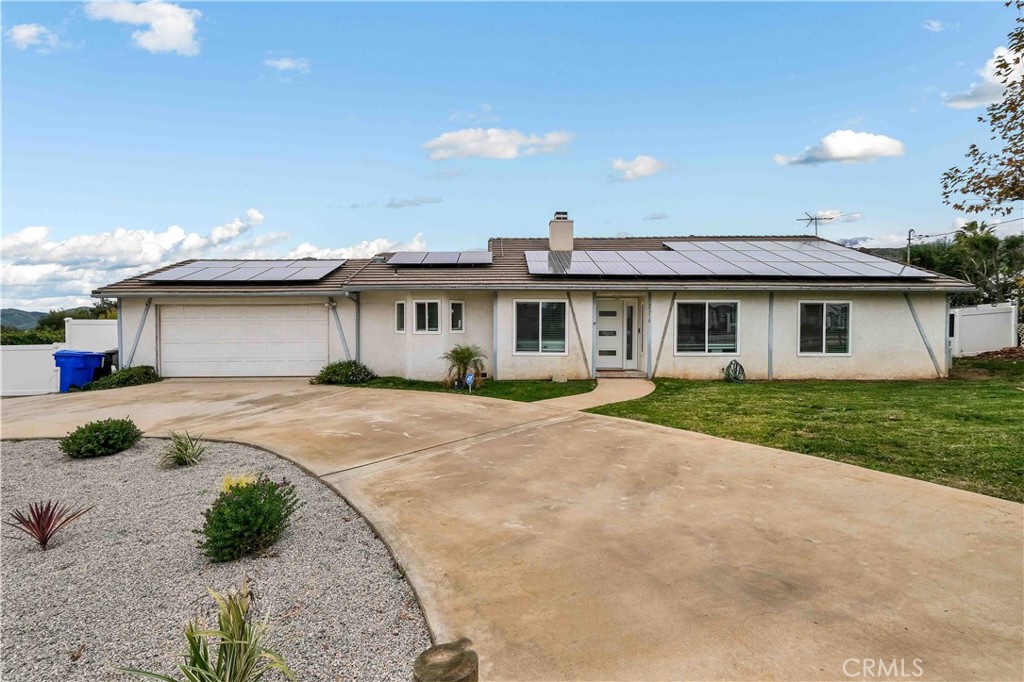35716 Wildwood Canyon Road Yucaipa, CA 92399 - Photo 5 of 57 a front view of a house with a garden